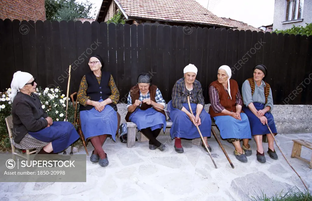 Bulgaria, Bansko, Six Old Ladies Sitting On Bench.