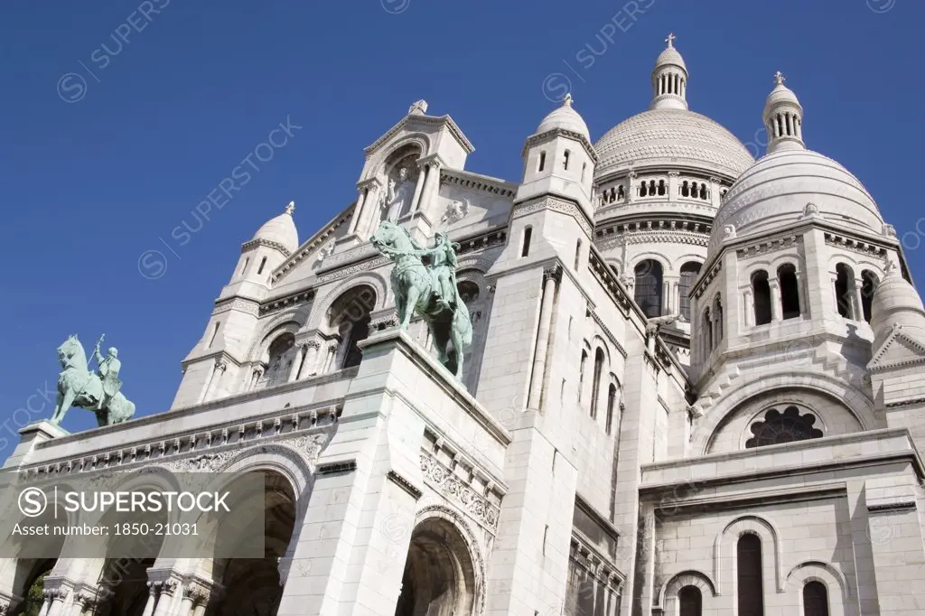 France, Ile De France, Paris, Montmartre The Facade Of The Church Of Sacre Couer With The Bronze Equestrian Statues Of Saint Louis And Joan Of Arc By H Levebure