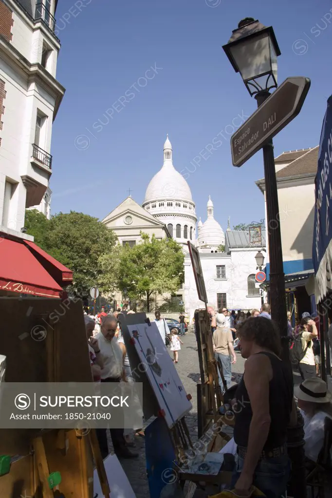 France, Ile De France, Paris, Montmartre Tourists Walking Past Artists Painting In Place Du Tertre Square Beside The Church Of Sacre Couer