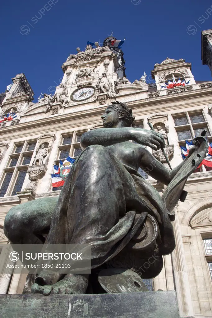 France, Ile De France, Paris, One Of Several Female Bronze Statues In Front Of The Hotel De Ville Town Hall Adorned With French Tricolour Flags