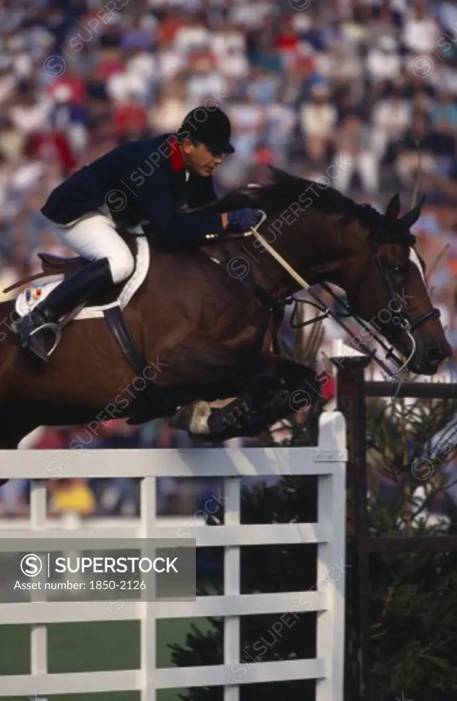 Sport , Equestrian, Show Jumping , 'French Rider Herve Godignon Competing In The 1993 Hickstead Derby, Clearing White Gates On Bay Horse.'