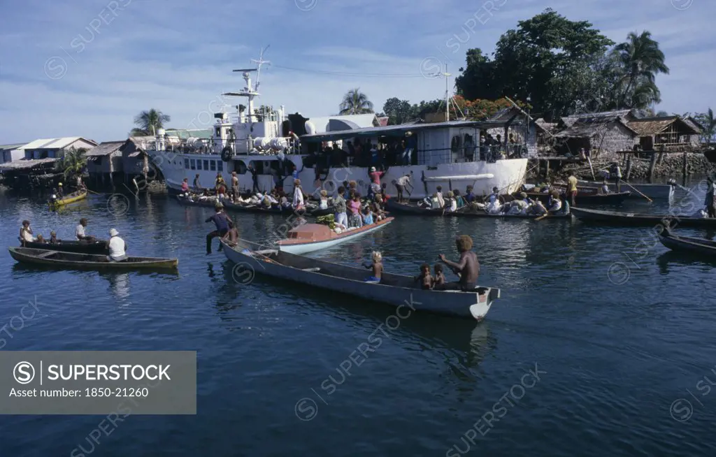 Pacific Islands, Melanesia, Solomon Islands, 'Malaita Province, Lau Lagoon. Weekly Boat Service Visiting Foueda Island Attracting Crowds In Canoes.  Thatched Housing Behind.  '