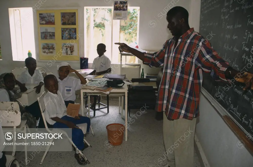 Nigeria, Kano, Teacher And Pupils In Classroom Of Private School.