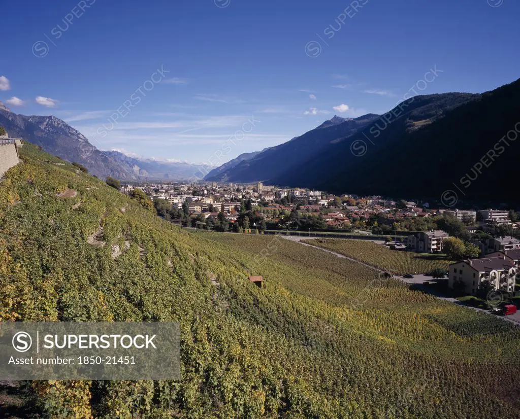 Switzerland, Valais, Martigny, Elevated View East Along Rhone Valley Above Vineyards And Town