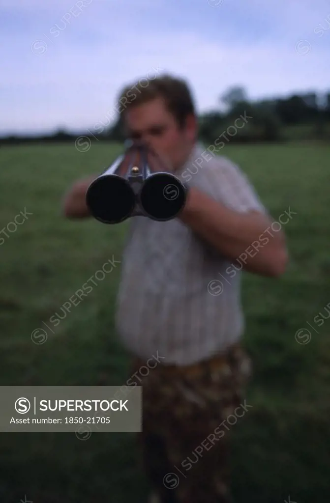 Sport, Shooting, Guns, Man Holding Double Barrelled Shotgun With Detail Of The Tip Of The Gun In Focus.