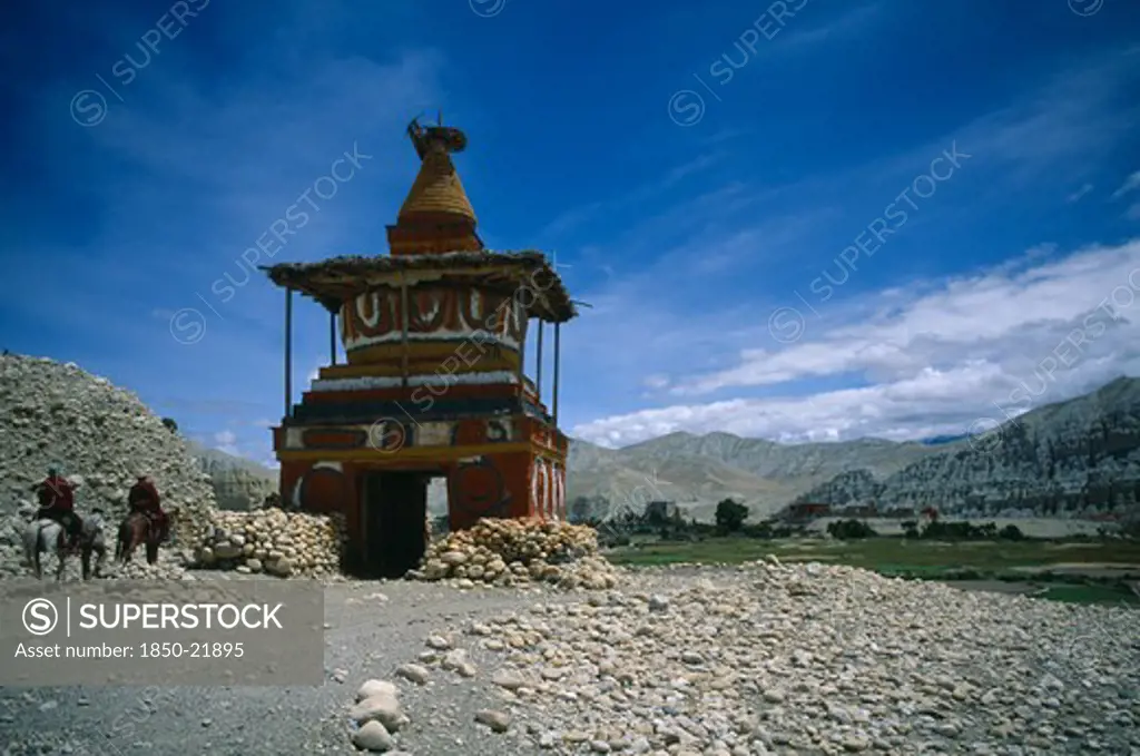 Nepal, Mustang, Tsarang, 'Old, Painted Stupa Marking Entrance To Tsarang With Two Horsemen Approaching.'
