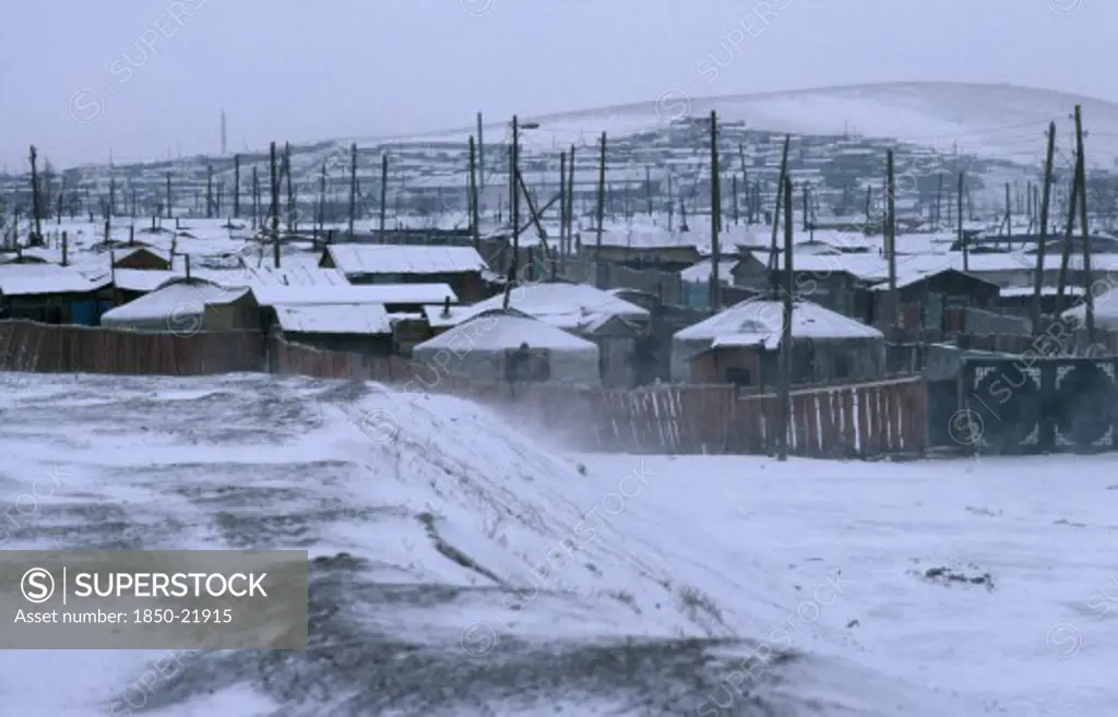 Mongolia, Ulan Bator, Traditional Housing In City Suburb In Windblown Winter Snow.