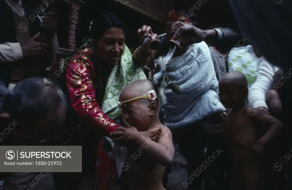 Nepal, Patan, Buddhist Priests And Family Bless Young Boy With Milk During His Bhartavan Or Manhood Ceremony.