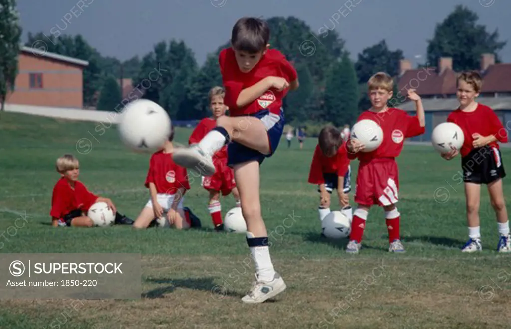 Sport, Ball Games, Football, Young Boy Kicking Football During Coaching Derby.