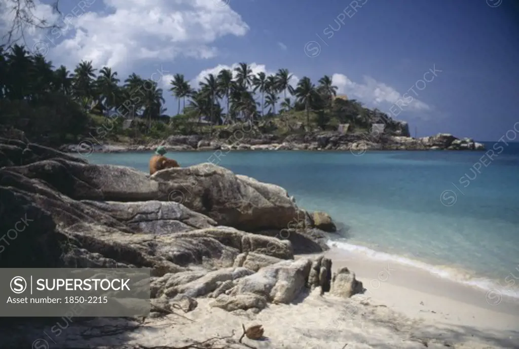 Thailand, Koh Pha-Ngan Island, Coral Bay, View From Beach Over Rocks Toward Bay Surrounded By Rocks And Palms