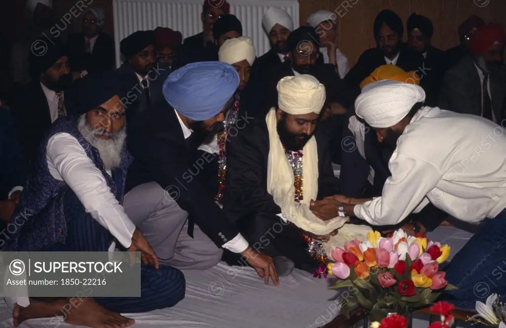 England, Religion, Sikhism, Groom Receiving Gifts From Guests During Wedding Ceremony.