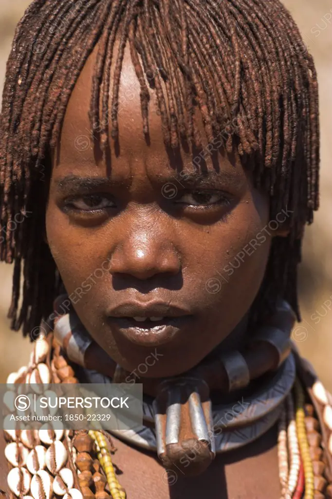 Ethiopia, Lower Omo Valley, Tumi, 'Hamer Jumping Of The Bulls Initiation Ceremony, Married Hamer Lady, Her Hair Greased With Ocher Colouring And Animal Fat Into Plaits Known As Goscha. She Is Wearing A Necklace Know As A Bignere - An Metal Band With A Phallic Protuberance To Signify That She Is A First Wif'