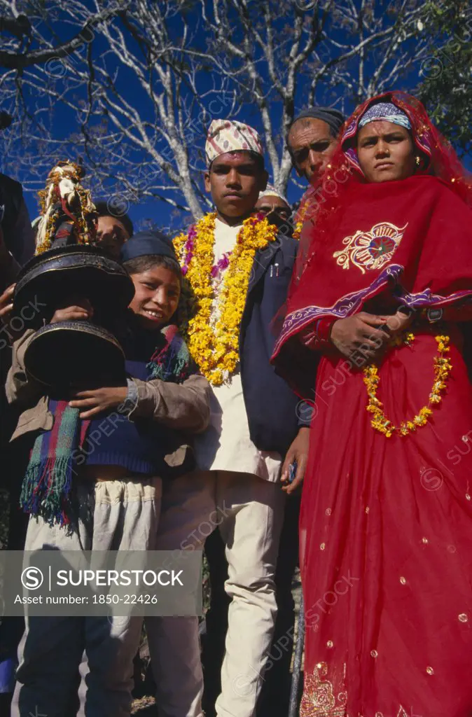 Nepal, East,  Sangawa Khola, Bride And Groom During Wedding Procession. Groom Wearing A Marigold Garland And Bride Dressed In Red.