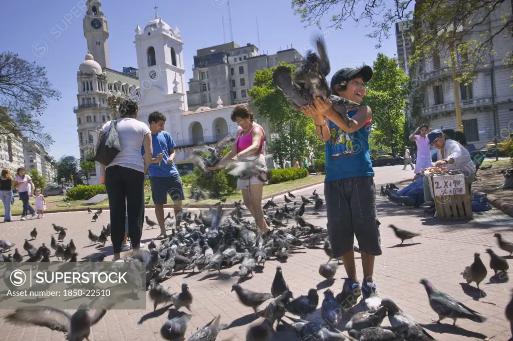 Argentina, Buenos Aires, Feeding The Pigeons In Plaza De Mayo.