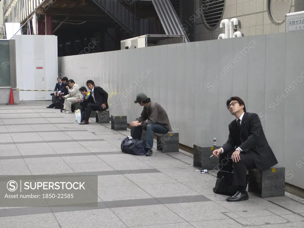 Japan, Honshu, Tokyo, 'Tokyo Station, Nihonbashi Entrance, Morning Commuters Take A Break Outside Before Going To Work, Some Smoke Cigarette'