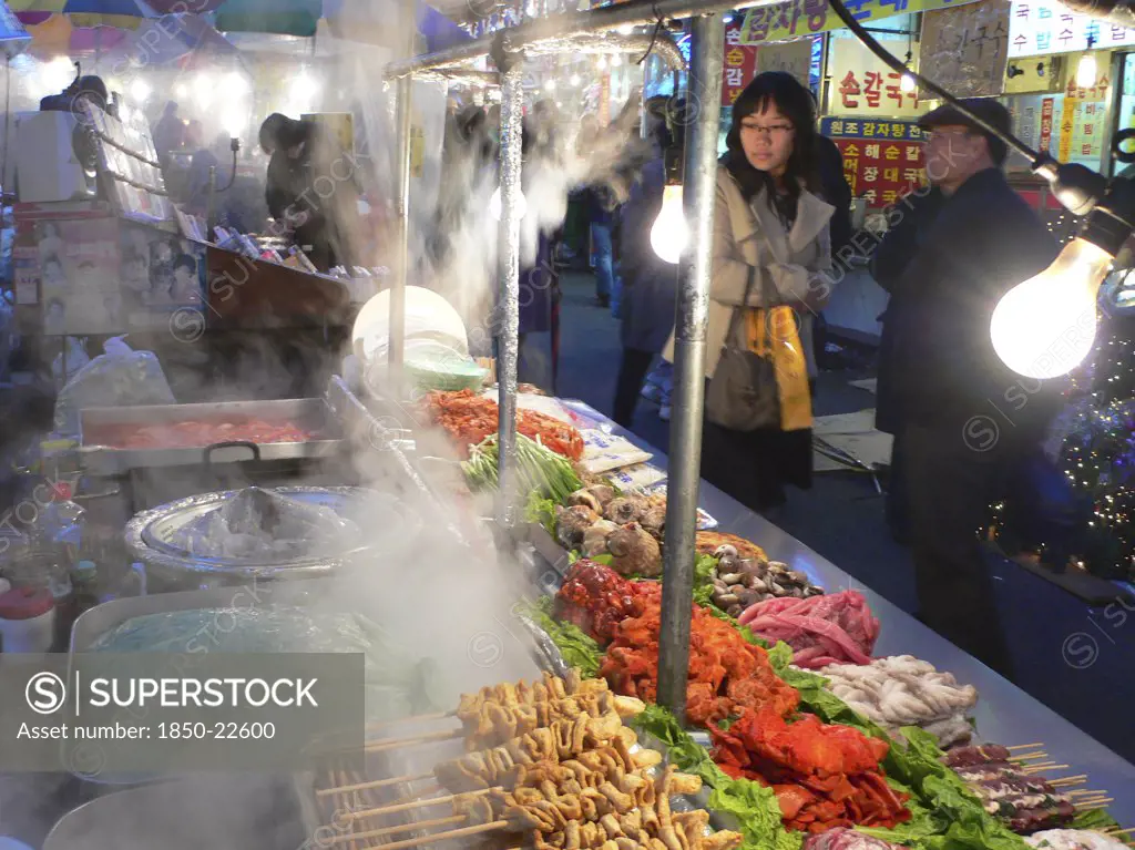 Korea, South, Seoul, 'Namdaemun - Namdademun Market, December Evening, Steam Rising From Food Stalls, Meat And Fish, People Walking By'