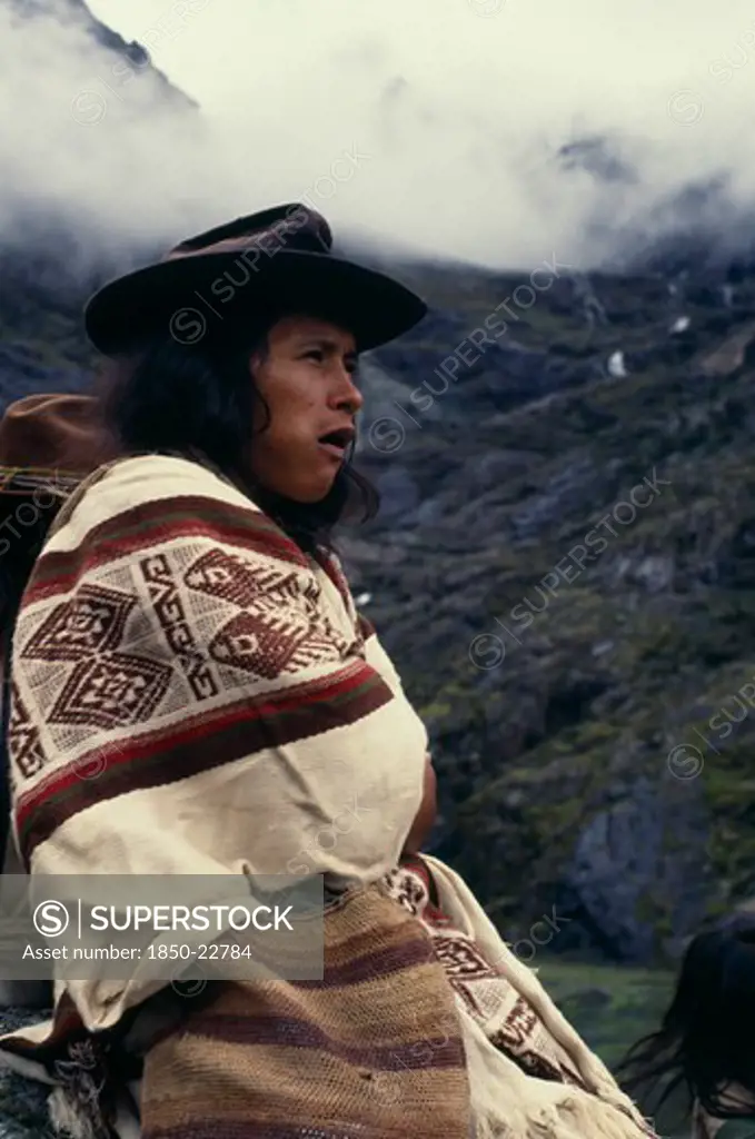 Colombia, Sierra Nevada De Santa Marta, Ika, Portrait Of Ika Shepherd Wrapped In Woven Wool&Cotton Manta Cloak  High In Sierra Nevada De Santa Marta. Arhuaco Aruaco Indigenous Tribe American Colombian Colombia Hispanic Indegent Latin America Latino South America  Arhuaco Aruaco Indigenous Tribe American Colombian Columbia Hispanic Indegent Latin America Latino South America Farming Agraian Agricultural Growing Husbandry  Land Producing Raising One Individual Solo Lone Solitary 1 Agriculture Sing