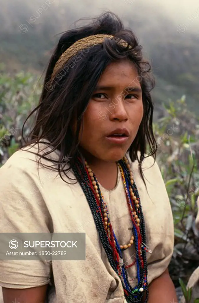 Colombia, Sierra Nevada De Santa Marta, Ika, Portrait Of Ika Shepherd Girl In The High Pastures Of The Sierra.Strings Of Coloured Glass Beads Denote Family Wealth Arhuaco Aruaco Indigenous Tribe American Colombian Colombia Female Lady Hispanic Indegent Latin America Latino South America  Arhuaco Aruaco Indigenous Tribe American Colombian Columbia Hispanic Indegent Latin America Latino South America Farming Agraian Agricultural Growing Husbandry  Land Producing Raising Immature One Individual Sol