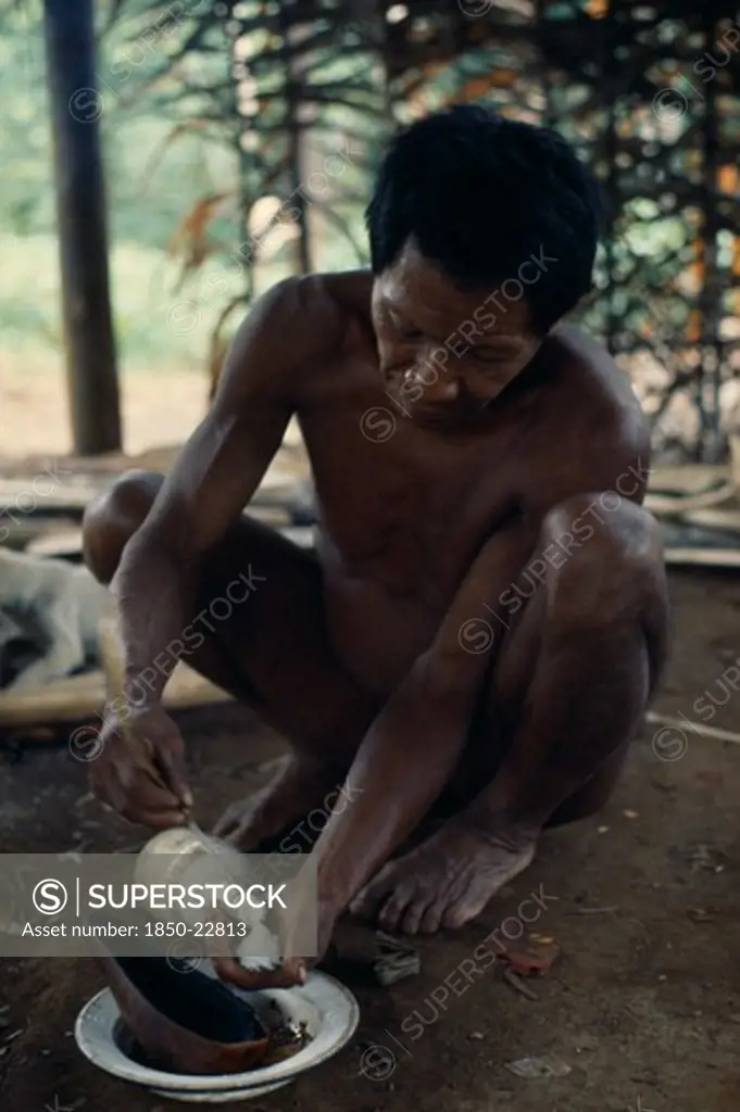 Colombia, North West Amazon, Vaupes, Maku Hunter Umero Taking Salt - A Valued Commodity  From Bottle. Indigenous Tribe Indian Nomadic American Colombian Columbia Hispanic Indegent Latin America Latino Male Men Guy South America Vaupes Male Man Guy One Individual Solo Lone Solitary Vaupes