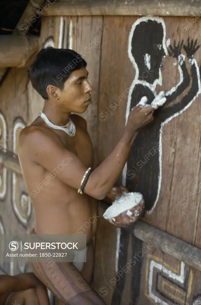 Colombia, North West Amazon, Tukano Indigenous People, Cropped Shot Of Barasana Indian Painting Spirit Guardian On Front Of Maloca  Communal Home. Tukano Sedentary Tribe Indian North Western Amazonia Maloca American Colombian Columbia Hispanic Indegent Latin America Latino Religion South America Tukano One Individual Solo Lone Solitary Religious