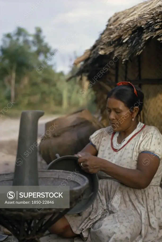 Colombia, North West Amazon, Tukano Indigenous People, Barasana Woman  Paulina  Headman Bosco'S Sister  Making Clay Cooking Pot. Note The Larger Fired Pot Behind Her. A Fine Potter Whose Death Has Marked The Virtual Extinction Of Pottery-Making Amongst The Barasana   Tukano Sedentary Indian Tribe North Western Amazonia American Colombian Columbia Female Women Girl Lady Hispanic Indegent Latin America Latino South America Tukano Female Woman Girl Lady One Individual Solo Lone Solitary