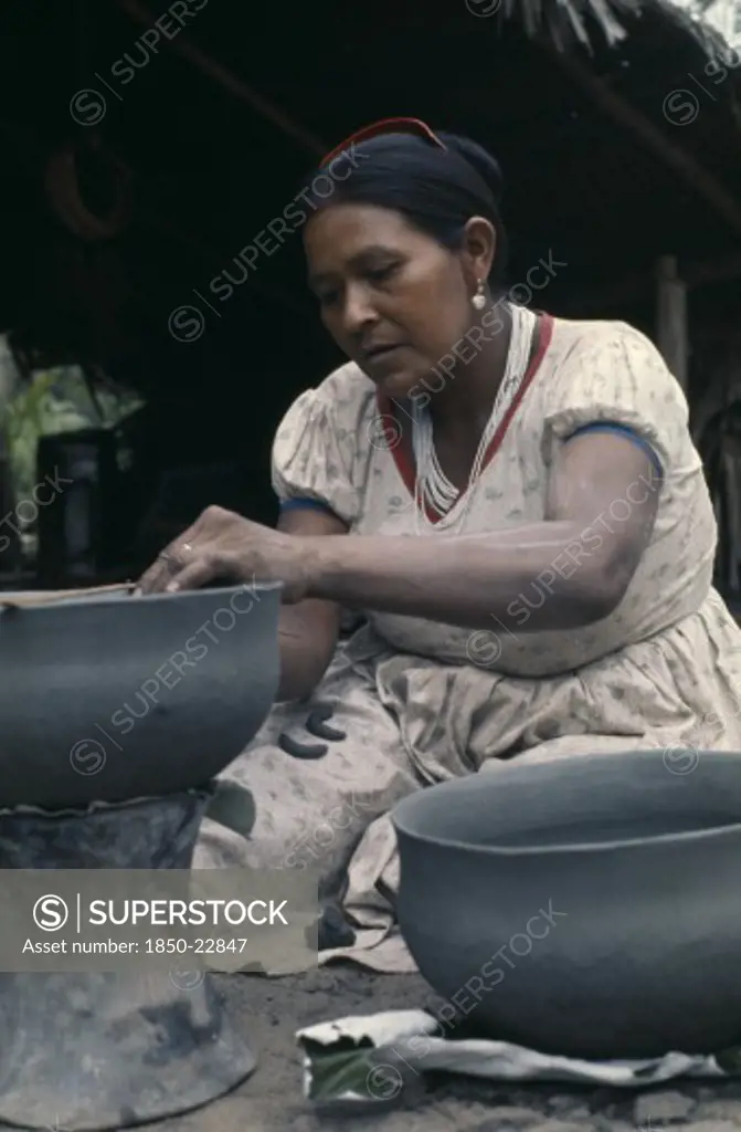 Colombia, North West Amazon, Tukano Indigenous People, Barasana Woman Paulina Making Clay Cooking Pot From Grey River Clay. Tukano Sedentary Indian Tribe North Western Amazonia American Colombian Columbia Female Women Girl Lady Hispanic Indegent Latin America Latino South America Tukano  Female Woman Girl Lady One Individual Solo Lone Solitary