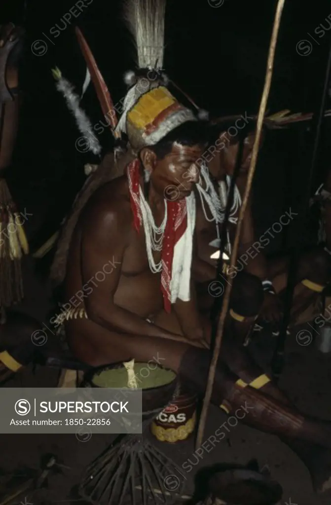 Colombia, North West Amazon, Tukano Indigenous People, 'Barasana Shamans And Elders Led By Revered Shaman Cristo Chant To Reach Ancient World Of Ancestors, Holding Sacred Hardwood Prayer Staves Some Wearing Ancient Quartz Pendants Wild Boar Teeth Belts And Traded White Glass Beads. Refined Coca Powder Handed Round By Gourd And Taken From Deer Bone Spoon'