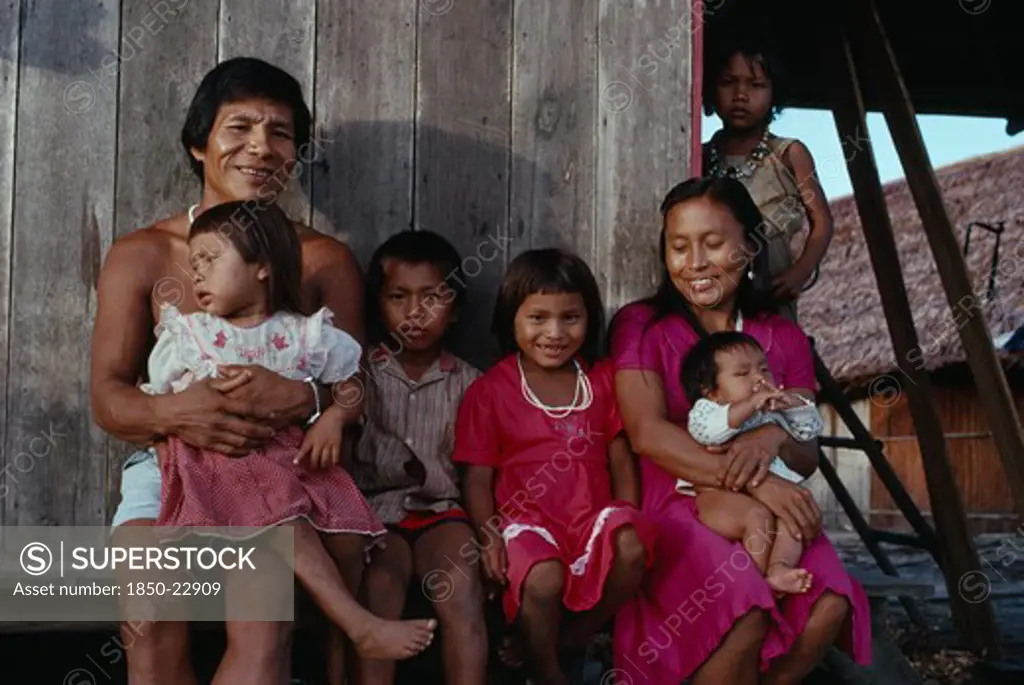 Colombia, North West Amazon, Tukano Indigenous People, Makuna Family - Venancio One Of Headman Bosco' Sons  With His Wife And Five Children Outside Their Recently Constructed Small Family Home. Venancio Is The Teacher In The Local Makuna School   Makuna Indian North Western Amazonia  Cassava American Colombian Columbia Hispanic Indegent Latin America Latino Male Men Guy South