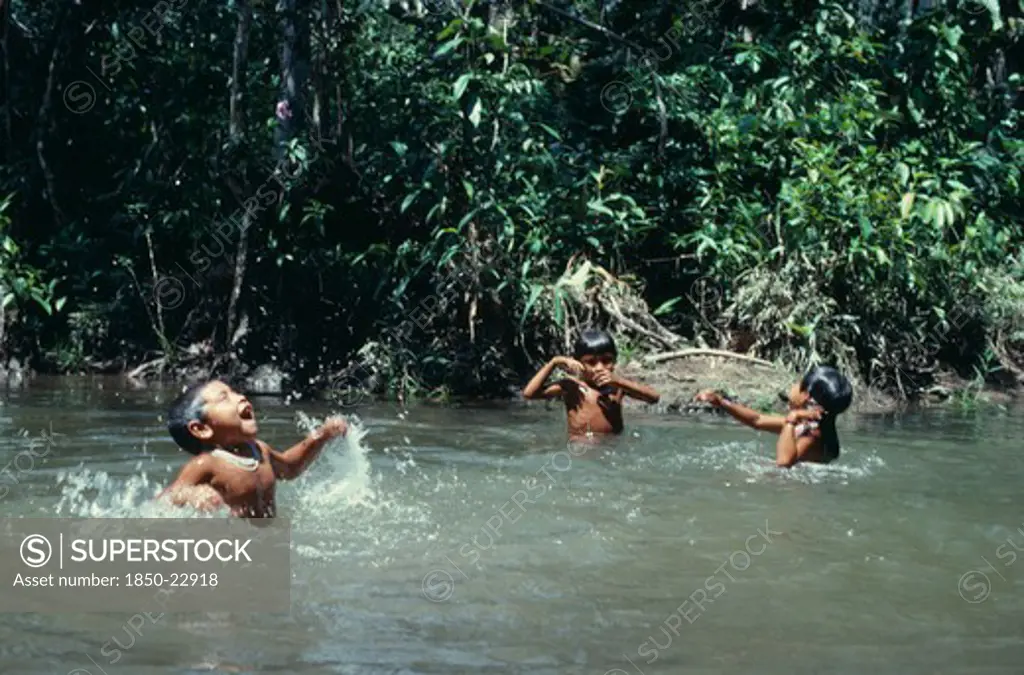 Colombia, North West Amazon, Tukano Indigenous People, Three Young Makuna Children Playing In Water At The Maloca'S River Port. Tukano Indian North Western Amazonia American Colombian Columbia Hispanic Indegent Kids Latin America Latino South America Tukano