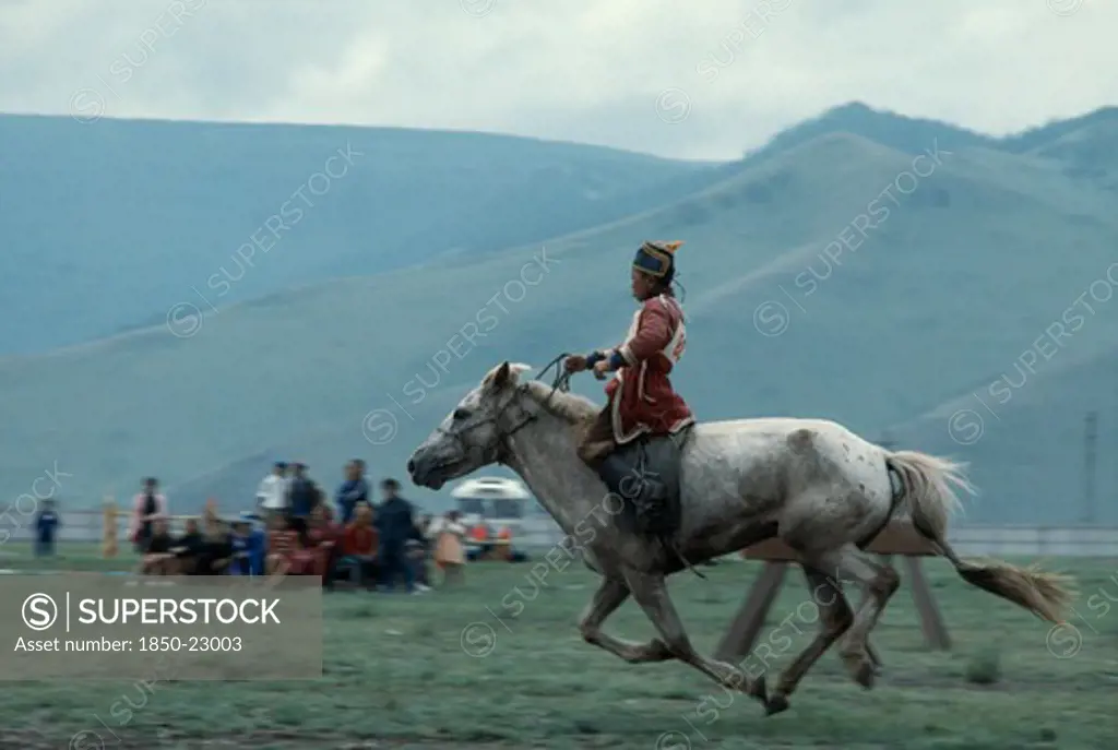 Mongolia, Ulan Bator, 'Nadam  National Day  Child Jockey Coming To End Of 20 Mile Cross Country Horse Race, All Jockeys Must Be Under 12 Years Old    Child Will Weigh Less And Not Overstretch The Horse. Ulaan Baatar East Asia Asian Baator Children Equestrian Mongol Uls Mongolian '