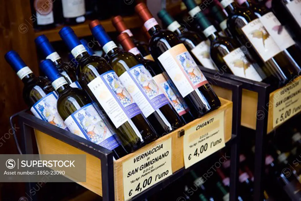 Italy, Tuscany, San Gimignano, Bottles Of Chianti And Vernaccia Di San Gimignano Wines Displayed For Sale Outside A Shop With Prices Given In Euros