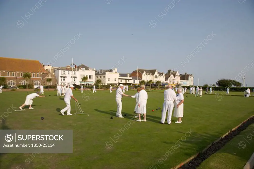 England, West Sussex, Bognor Regis, Men And Women Playing A Game Of Bowls On Beach Front Green