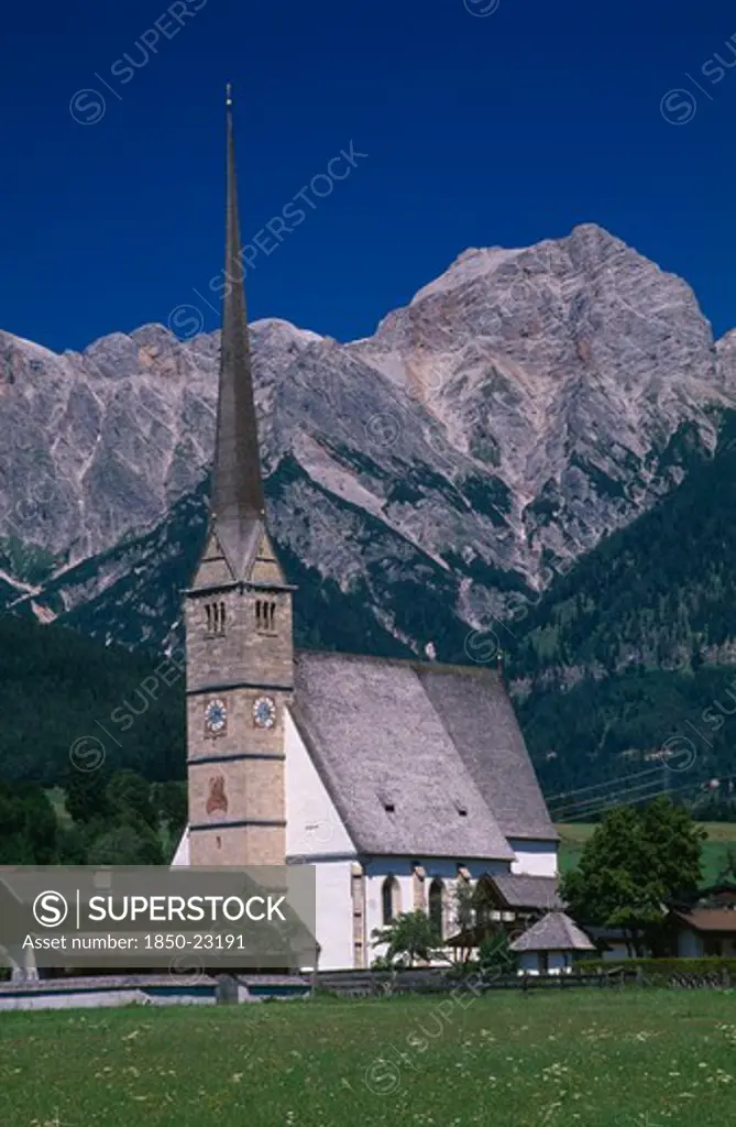 Austria, Salzburg, Maria Alm Am Steinernen Meer, 'Parish Church Exterior With Long, Narrow Spire With Hochkonig Mountain Range Behind.  Near Saalfelden.'