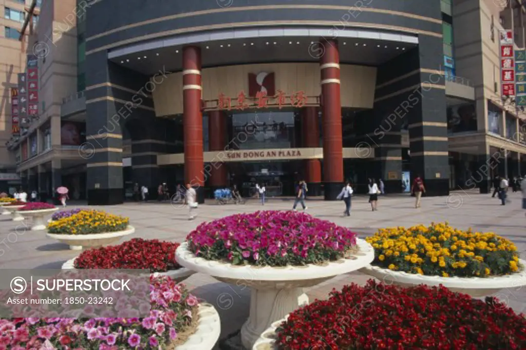 China, Beijing, Raised Circular Flower Beds Outside Sun Dong An Plaza Shopping Mall Entrance On Wangfujing Street.