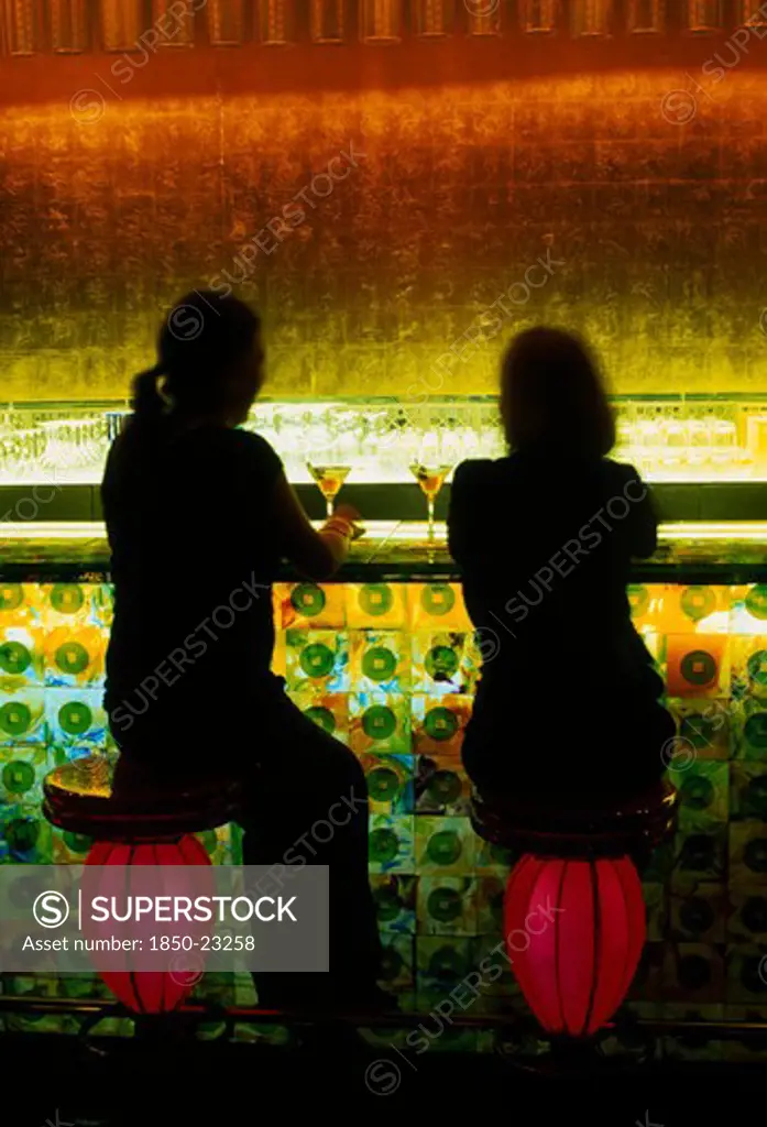 China, Shanghai, Xintiandi District.  Tou Ming Si Kao ( Tmsk ) Bar Interior With Two Figures Having Cocktails Seated At Illuminated Glass Bar On Stools Resembling Chinese Lanterns.