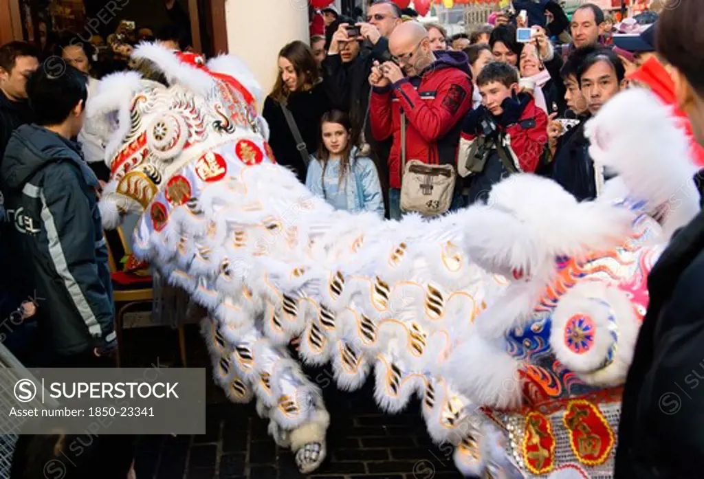 England, London, Chinatown, Lion Dance Troupe And Embroidered Banners In Gerrard Street Amongst The Crowd During Chinese New Year Celebrations In 2006 For The Coming Year Of The Dog