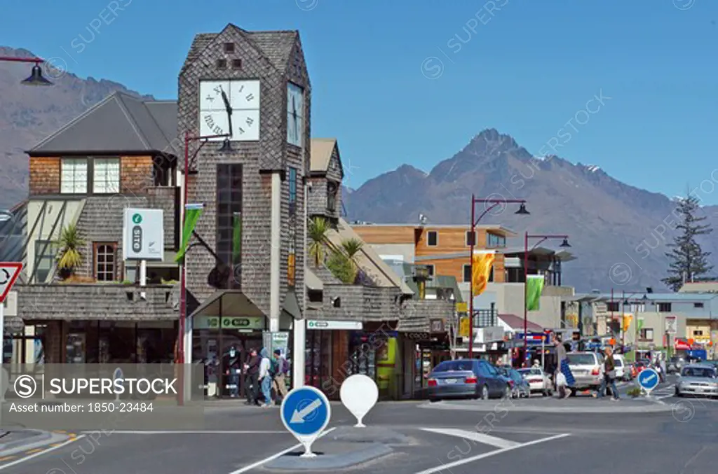 New Zealand, South Island, Otago, 'Queenstown, View Of Tourist Information Centre Left Looking Down Along Shotover Street At The Junction With Camp Street With Walter Peak In The Background.'