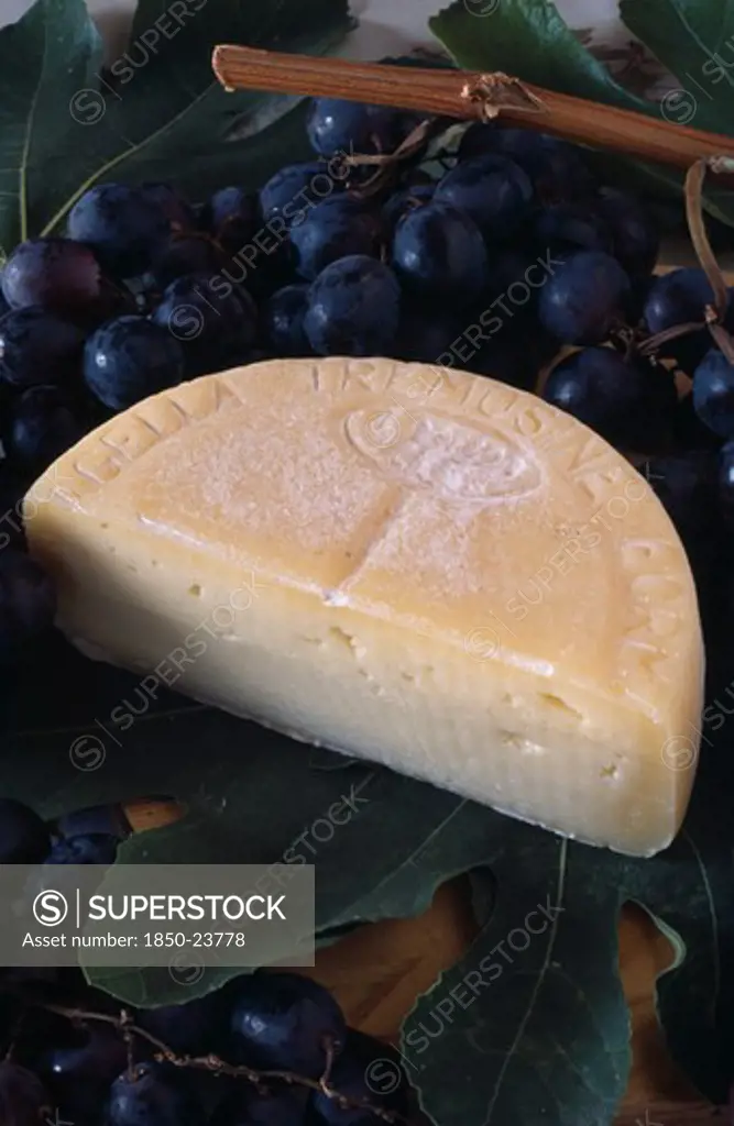 Italy, Lake Garda Area, Tremosine Cheese And Grapes Used In Locally Produced Bardolino Wine.