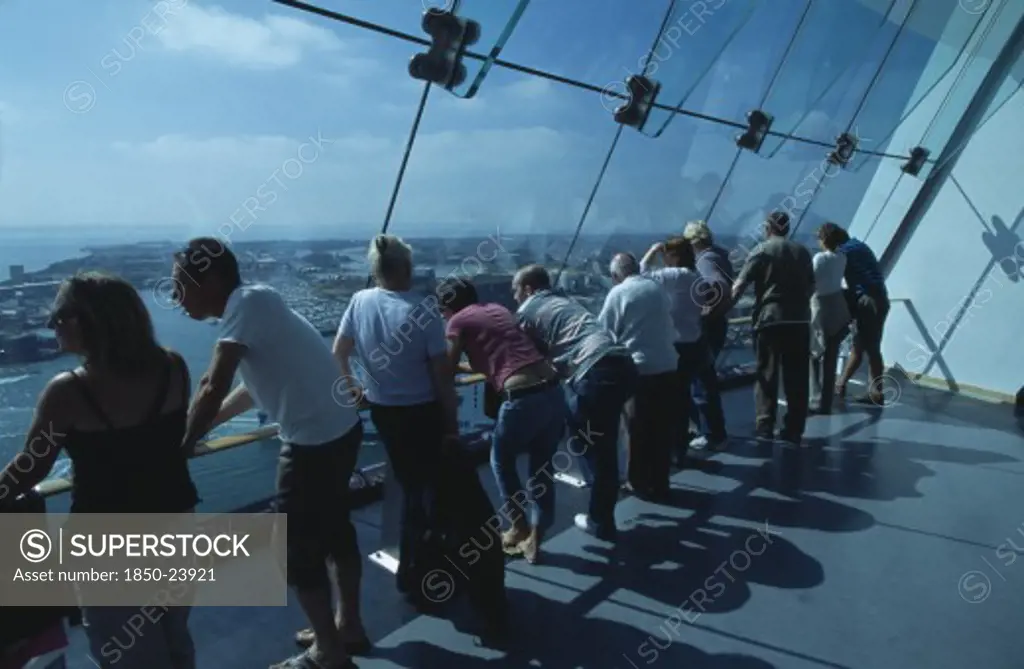 England, Hampshire, Portsmouth, 'Gunwharf Quays. The Spinnaker Tower. Interior With Visitors Looking Out Of Glass Windows On The Top Observation Deck, Providing A 320 View Of The City Of Portsmouth, The Langstone And Portsmouth Harbours, And A Viewing Distance Of 37 Kilometres (23 Miles)'