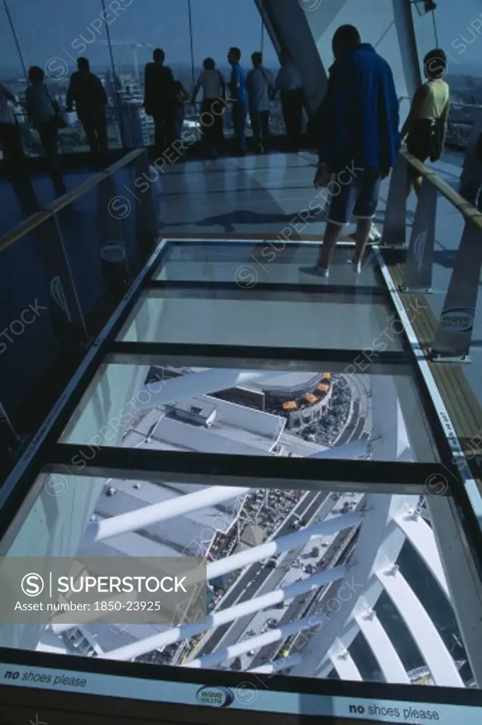 England, Hampshire, Portsmouth, 'Gunwharf Quays. The Spinnaker Tower. Interior At Top Of Tower With A Glass Floor Window  Looking Down.Visitors Looking Out Glass Windows On The Observation Deck Providing A 320 View Of The City Of Portsmouth, The Langstone And Portsmouth Harbours.'