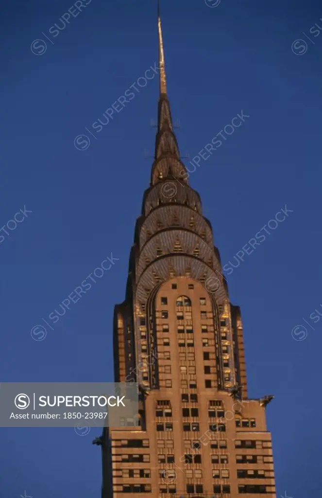 Usa, New York, New York City, Part View Of The Chrysler Building From East 42Nd Street Lit By Golden Light.  Steel Framed Art Deco Skyscraper Built 1928-1930 And Designed By Architect William Van Alen.