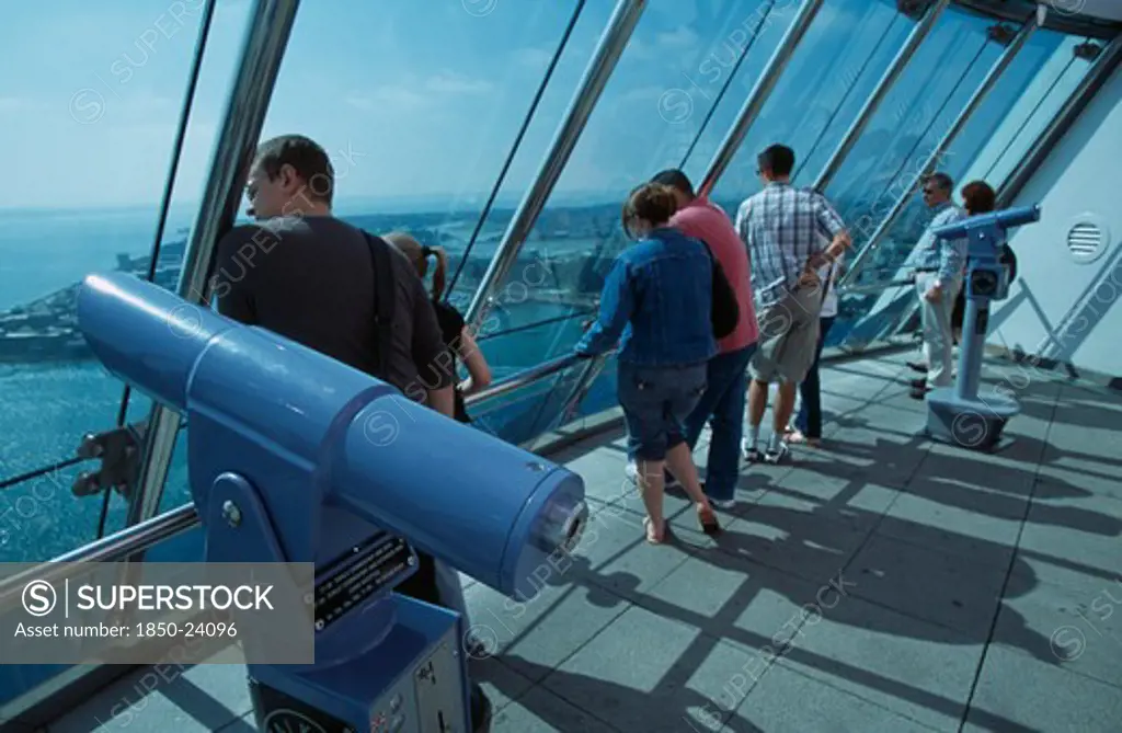 England, Hampshire, Portsmouth, 'Gunwharf Quays. The Spinnaker Tower. Interior At Top Of Tower On The Observation Deck With Visitors Looking Out Of Glass Windows Providing A 320 View Of The City Of Portsmouth, The Langstone And Portsmouth Harbours, And A Viewing Distance Of 37 Kilometres (23 Miles'