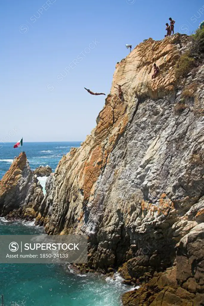 Mexico, Guerrero State, Acapulco, 'Cliff Diver, A Clavadista, Diving Off The Cliffs At La Quebrada'