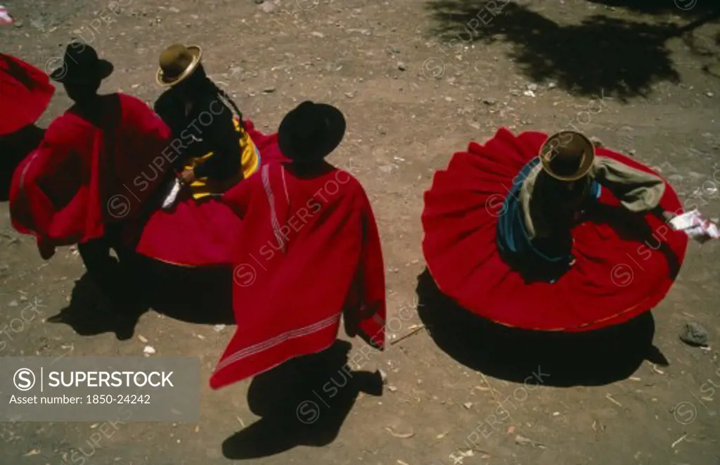Peru, Puno, Lake Titicaca, Aymara Andean Indian Dancers Wearing Red Skirts And Ponchos During Marriage Festivities