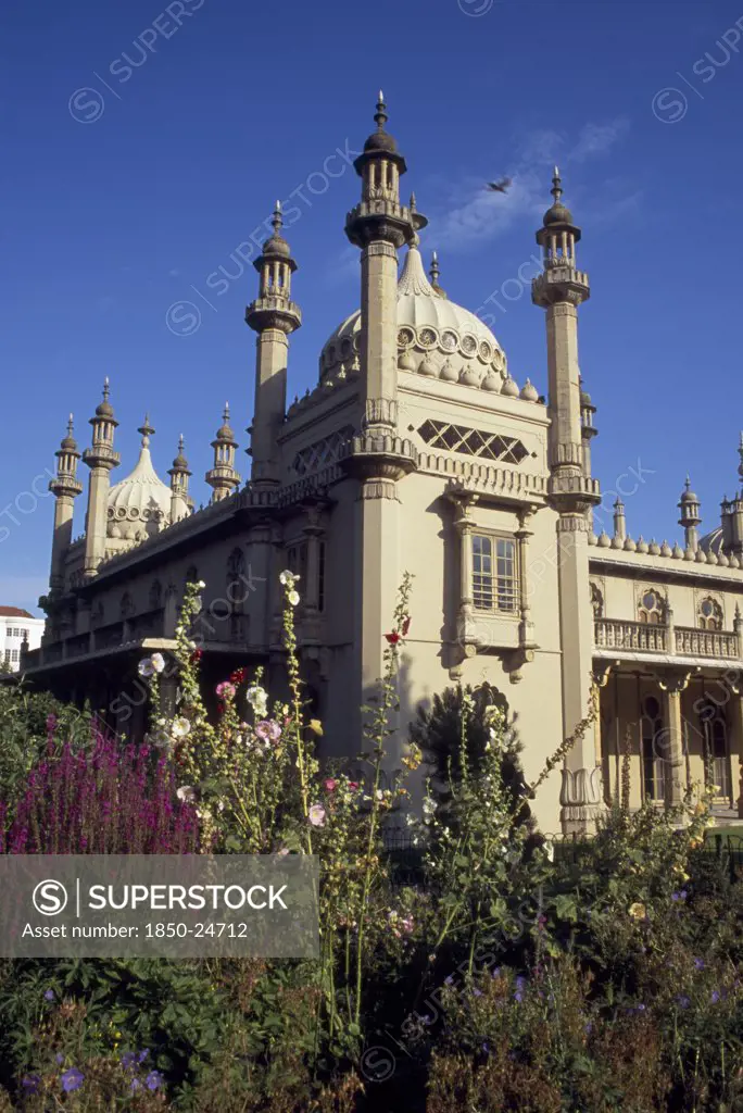 England, East Sussex, Brighton, Part View Of The Royal Pavilion Seen From The Gardens With Plants And Flowers In The Foreground