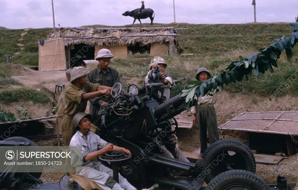 Vietnam, North Central, Thanh Hoa, 'Members Of Militia Unit, Not Regular Army With Anti-Aircraft Missile Launcher.  Child Riding Water Buffalo On Crest Of Hill Behind.'