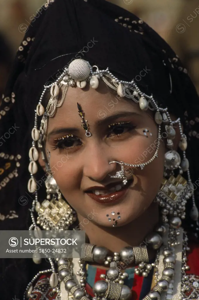 India, Rajasthan, Jaisalmer, Head And Shoulders Portrait Of A Miss Desert Contestant  Wearing Traditional Jewellery At The Desert Festival
