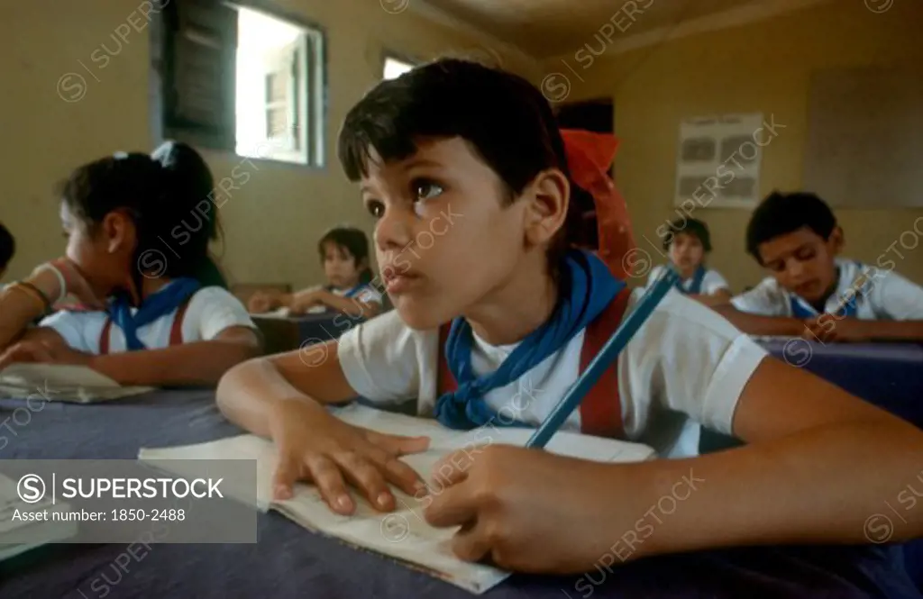 Cuba,  , Holguin, Children In Classsroom Writing Whilst Looking Toward Top Of The Class