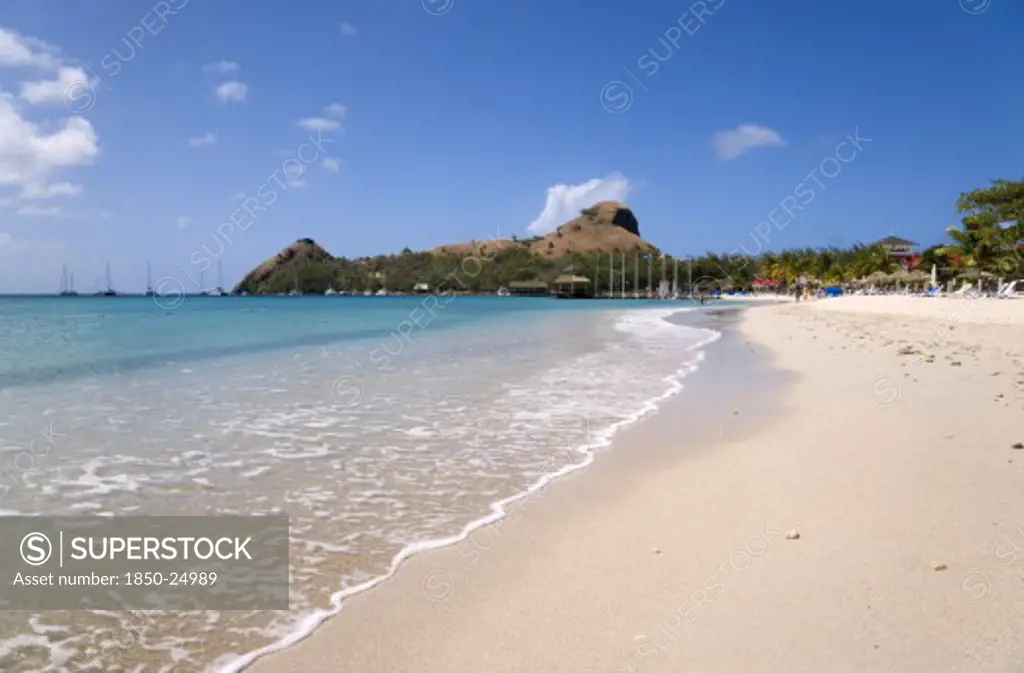 West Indies, St Lucia, Gros Islet , The Beach At Sandals Grande St Lucian Spa And Beach Resort Hotel With Pigeon Island National Historic Park Beyond