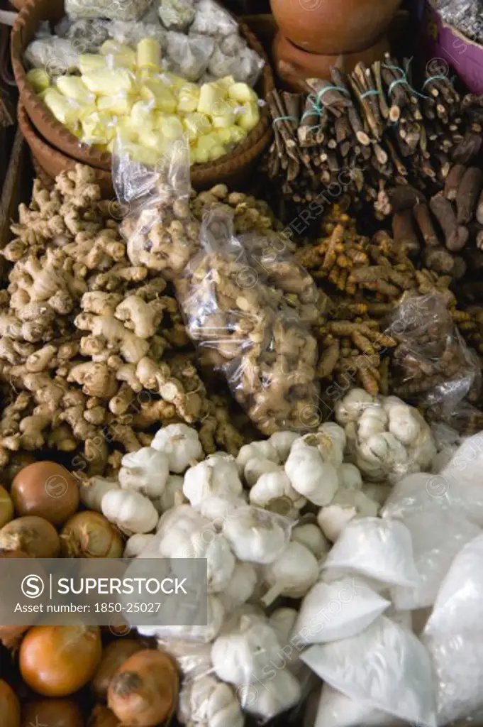 West Indies, St Lucia, Castries, 'Market Stall With Local Produce Of Herbs And Spices Including Ginger, Galangal, Garlic And Onions'